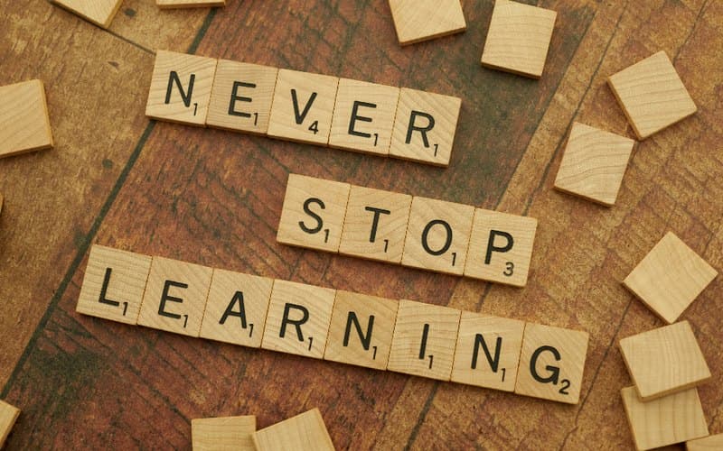 Letter tiles spelling the phrase never stop learning